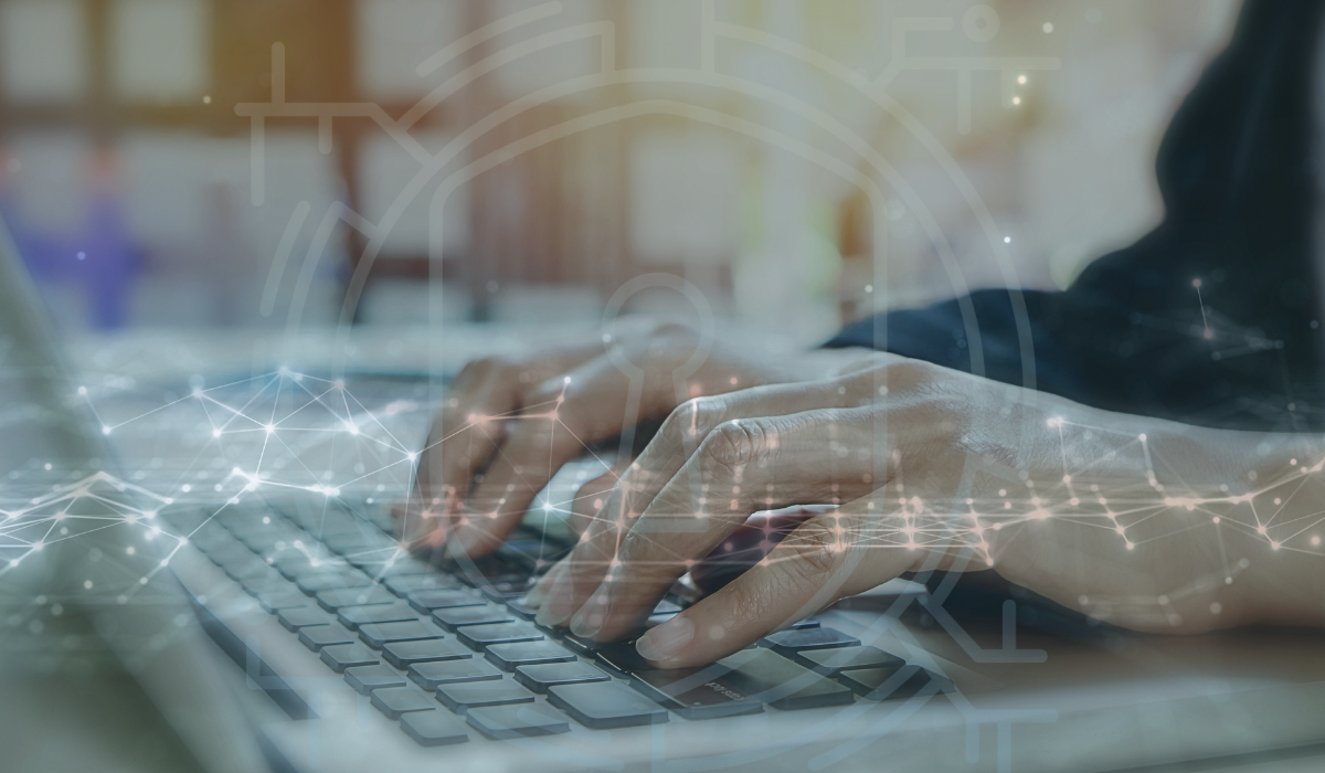 a photo of hands typing on a laptop overlaid by circles and hexagons connected by overlapping lines. There is also transparent code overlaying the image as well.